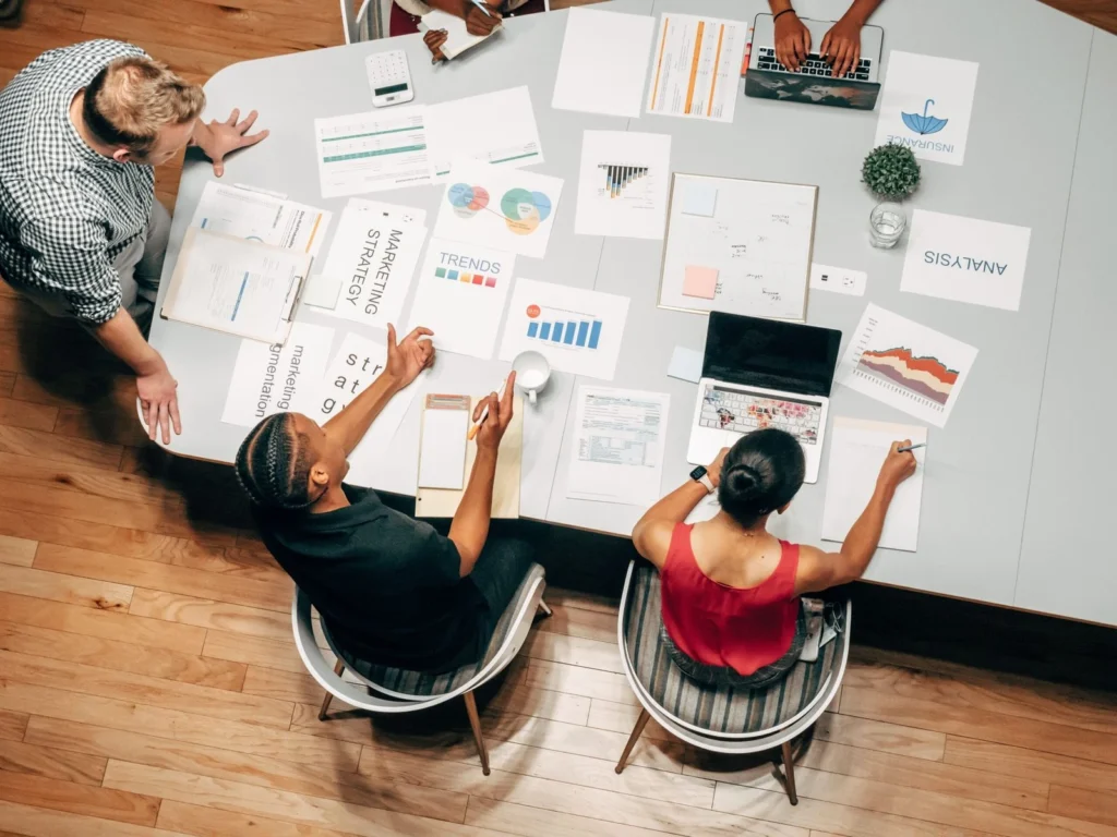 Freelance digital marketing strategist in Kerala collaborating with a team to analyze marketing reports and plan digital strategies.